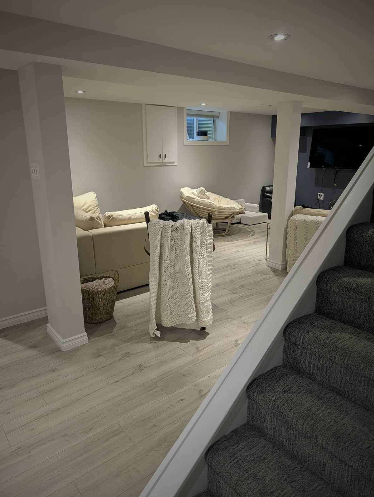 Finished basement family room with flat ceilings and recessed lighting