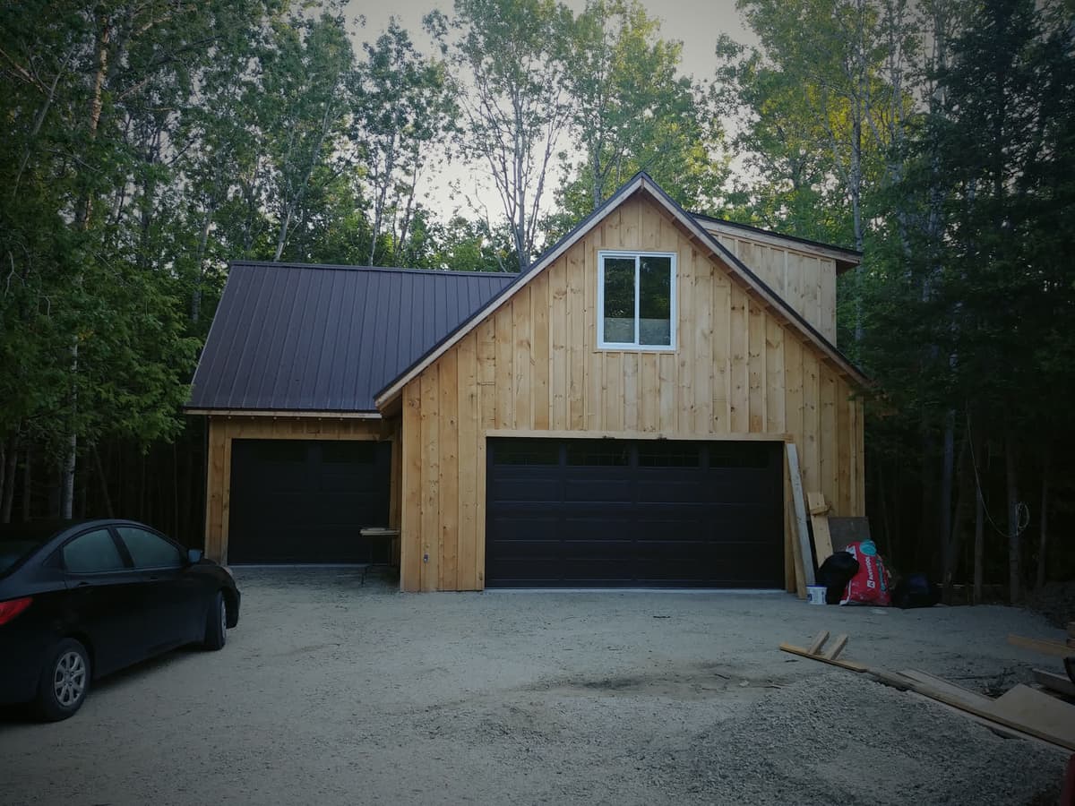 Finished two storey board-and-batten building with a metal roof, built by Hawthorn Construction