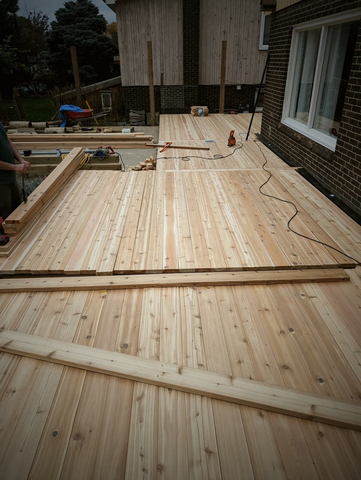 Finished cedar deck with mitred border boards along the back of a house
