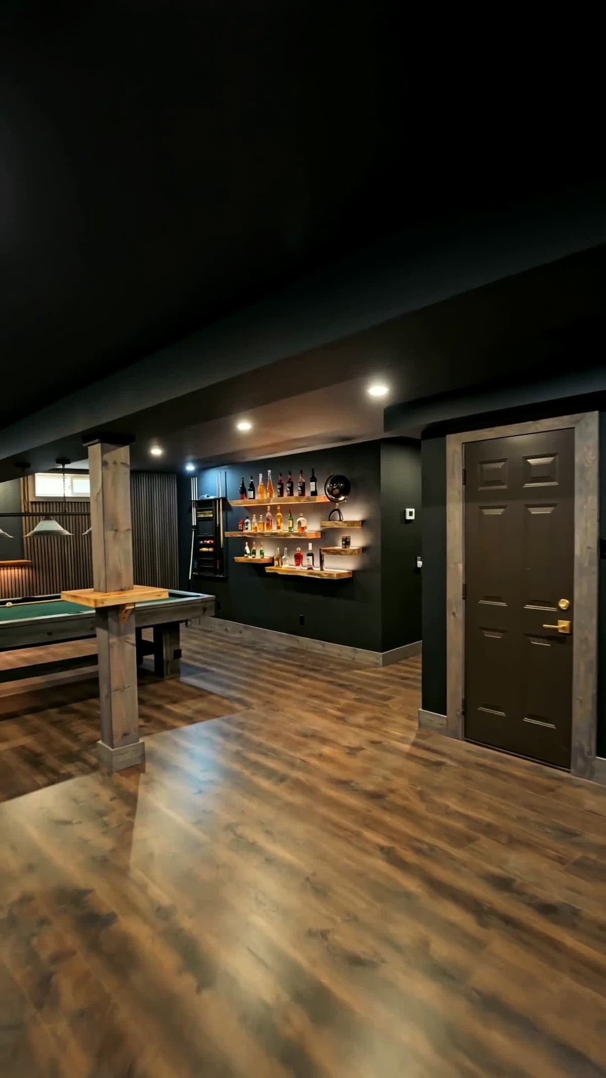 Finished basement lounge with billiards table and timber post